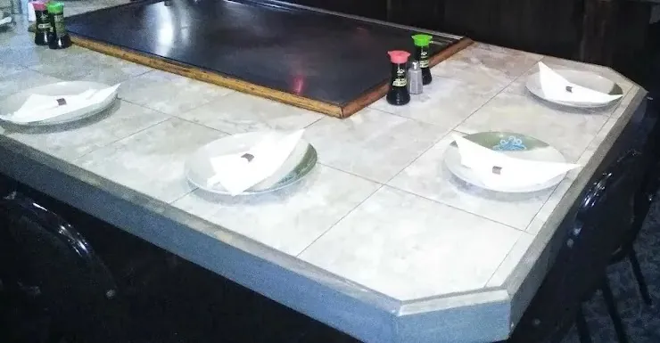 White plates set around a hibachi grill table at Tokyo Steak & Seafood